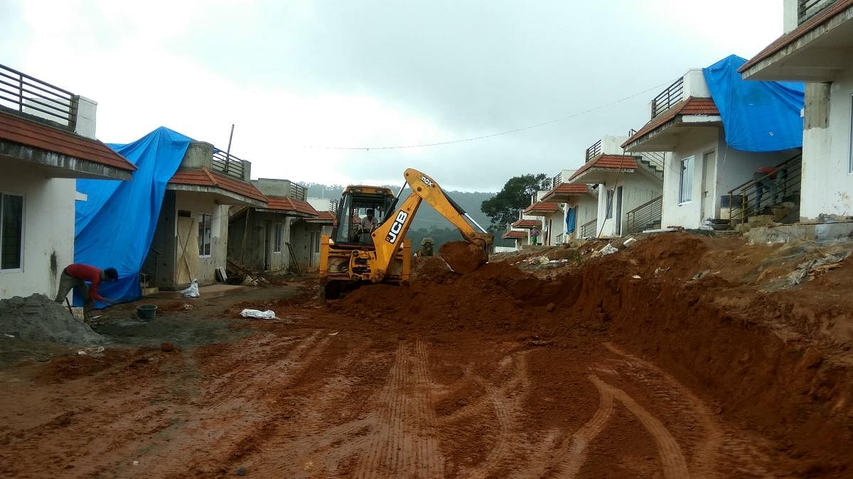 An excavator works on road construction at a group housing site in Made, near Madikeri.DH Photo/chiranjeevi kulkarni