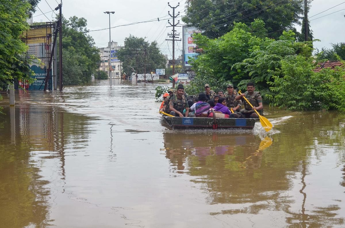 Indian Army personnel rescue people stranded in floodwaters after heavy rains on the outskirts of Sangli in Maharashtra state. AFP file photo