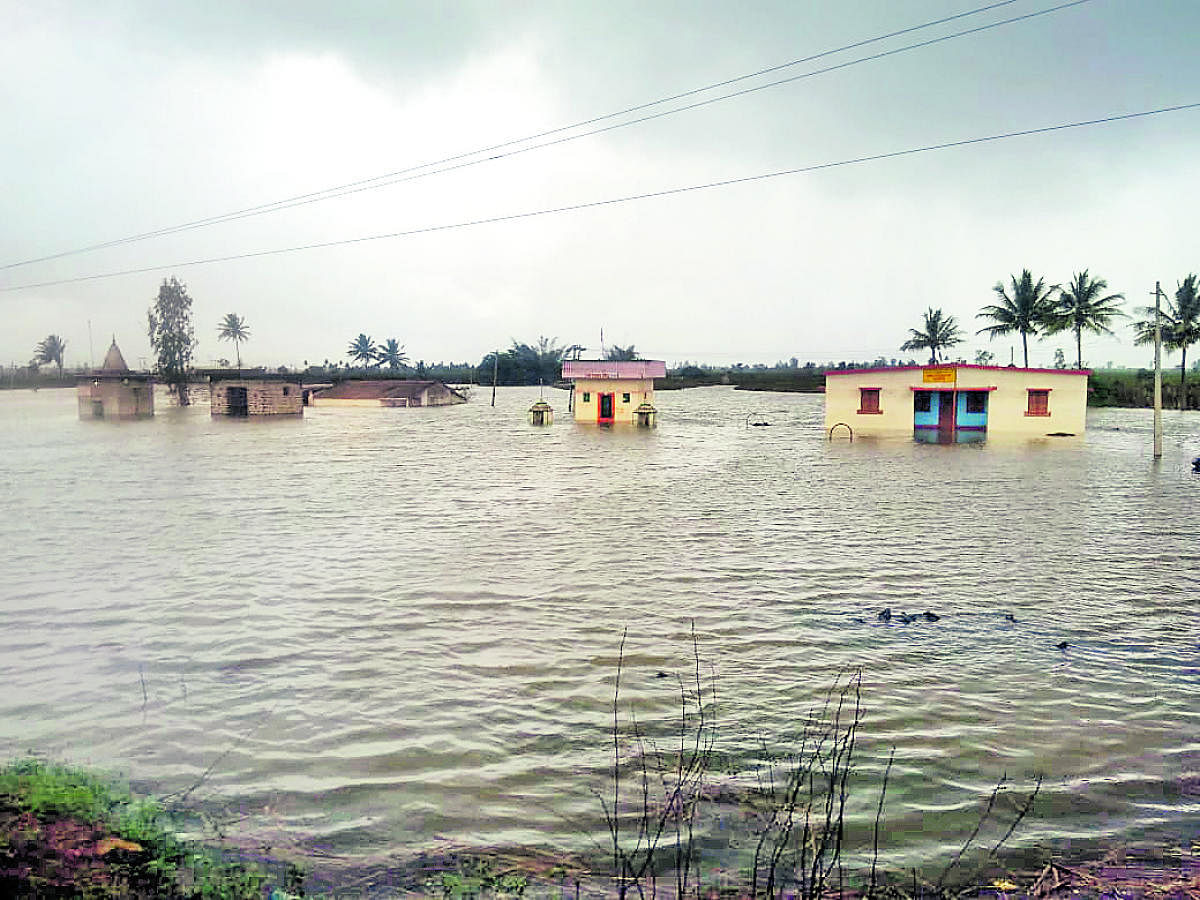 Veterinary hospital, temples are under water following floods in River Doodhganga in Karadaga village of Nippani taluk, Belgavi district on Tuesday. DH Photo