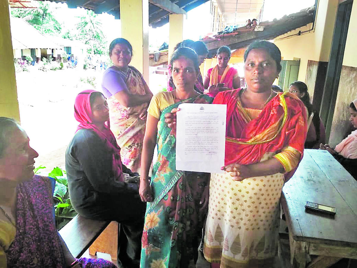 Flood victims in Siddapura, Kodagu district, show the letter of undertaking allegedly distributed to them by the revenue department officials.