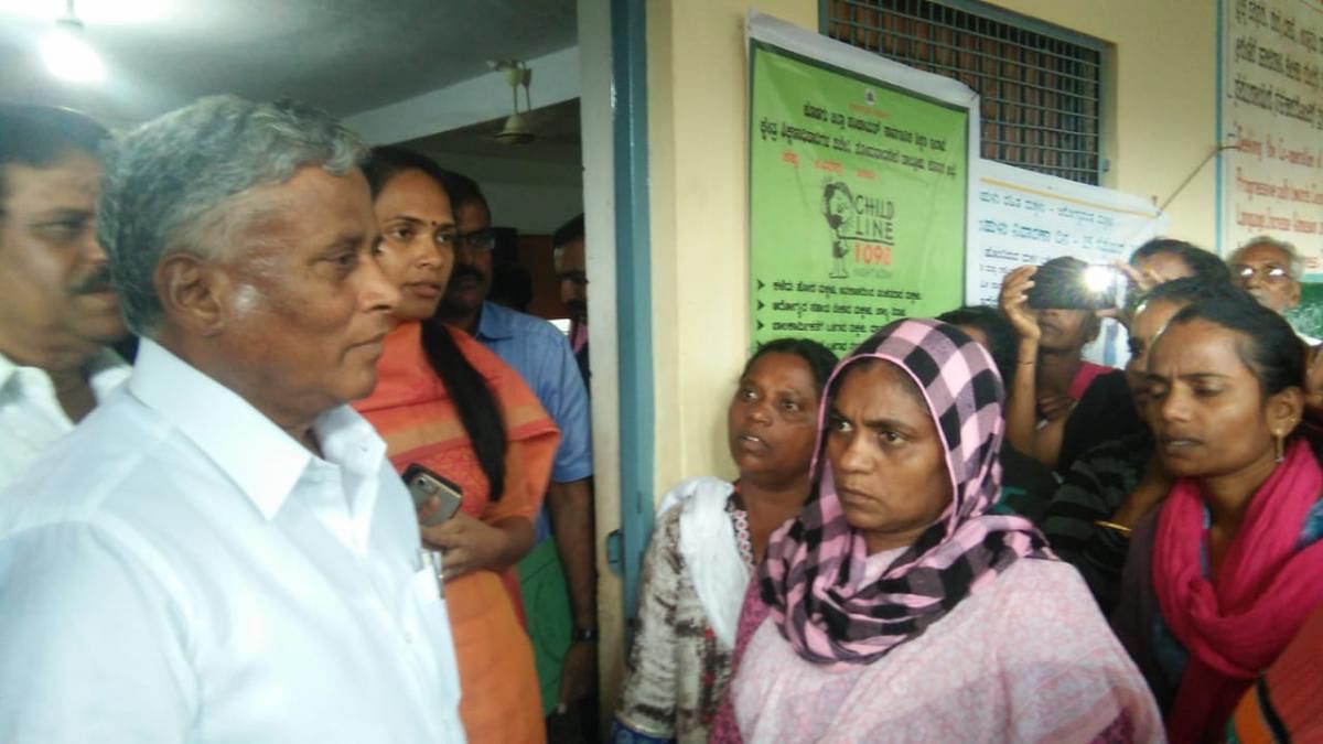 District In-charge Minister V Somanna interacts with the flood victims at the relief centre in Nelyahudikeri on Friday. Deputy Commissioner Annies Kanmani Joy looks on.