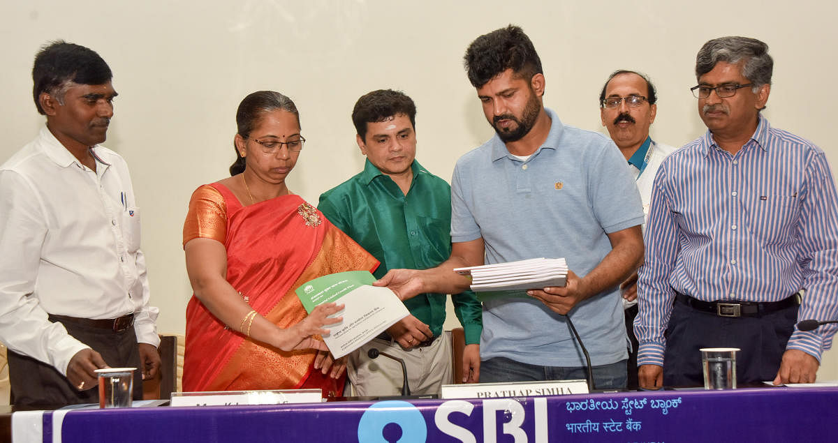 MP Pratap Simha releases Potential Linker Credit Plan 2020-21 during the quarterly progress review meeting, at Zilla Panchayat auditorium in Mysuru on Wednesday. Lead Bank Manager Venkatachalapathy and ZP CEO, also in-charge Deputy Commissioner, K Jyothi