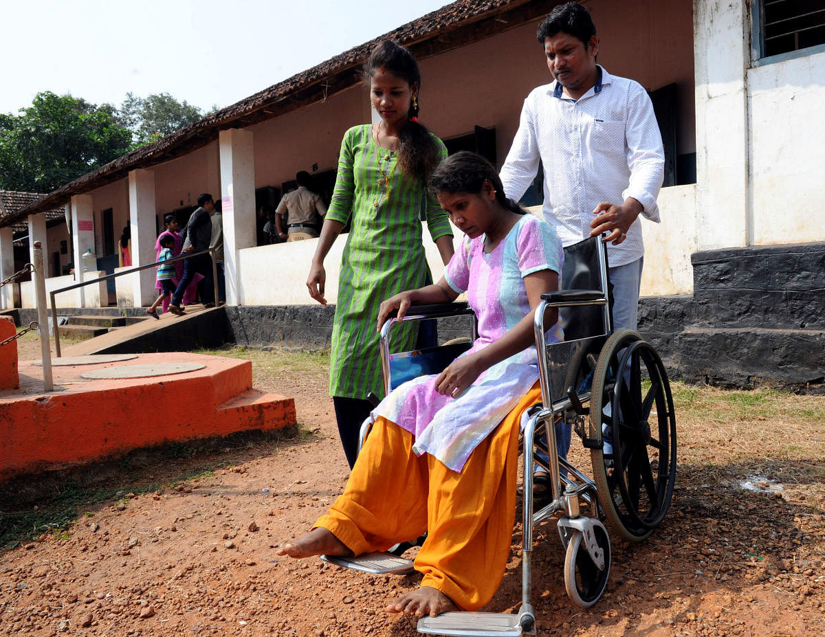 Kamala, an injured citizen, arrives in a wheelchair with the help of her relatives to the voting booth at Kodikal to cast her vote for the MCC Council elections on Tuesday.
