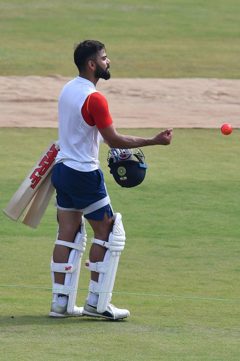 Indian cricket captain Virat Kohli throws a pink ball during a training session at the Holkar stadium on Wednesday. AFP 