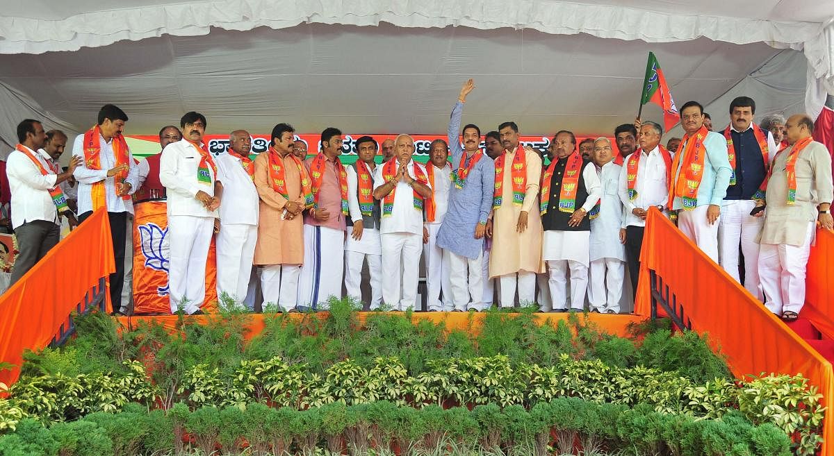 Karnataka Chief Minister B S Yediyurappa, BJP State Unit President Nalin Kumar Kateel and BJP National general secretary Muralidhar Rao with disqualified MLAs. PTI