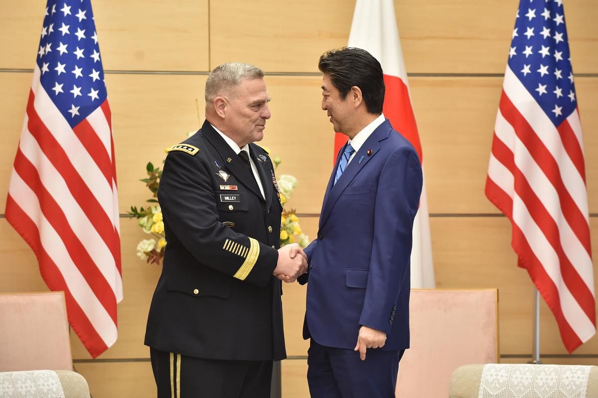Japan's Prime Minister Shinzo Abe shakes hands with US Chairman of the Joint Chiefs of Staff Gen. Mark Milley. Representative Image. (AFP Photo)