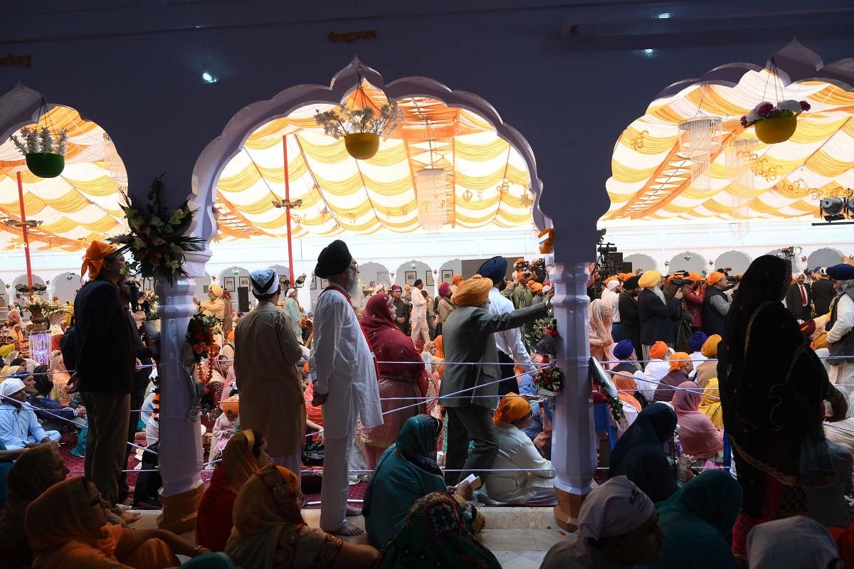 Sikh pilgrims take part in a religious ritual as they gather to celebrate the 550th birth anniversary of Guru Nanak Dev.