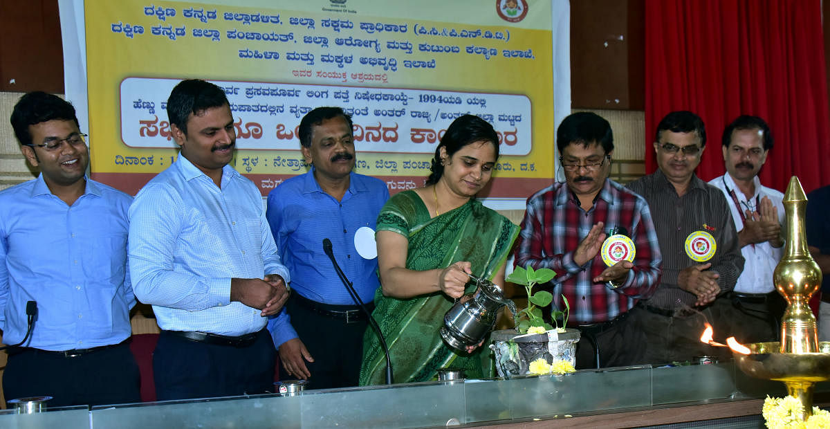 Deputy Commissioner Sindhu B Roopesh inaugurates a workshop on Pre-conception and Pre-natal Diagnostic Techniques Act by watering a plant at the Zilla Panchayat auditorium in Mangaluru on Wednesday.