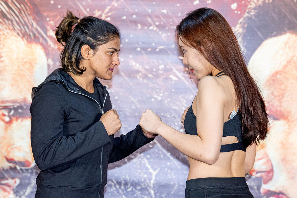 India's Ritu Phogat and South Korea’s Kim Nam-hee face off in Beijing. (Photo by Reuters)