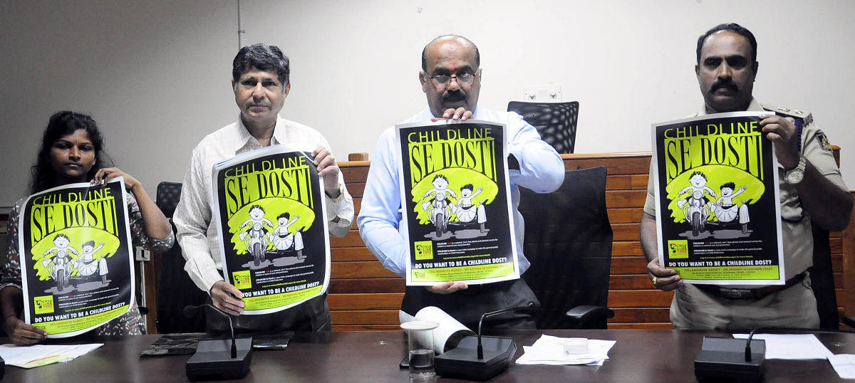 Udupi Additional Deputy Commissioner (ADC) Sadashiv Prabhu (second from right) and others release posters to create awareness on the week-long campaign 'Child Helpline Se Dosti' in Udupi on Wednesday. DH photo