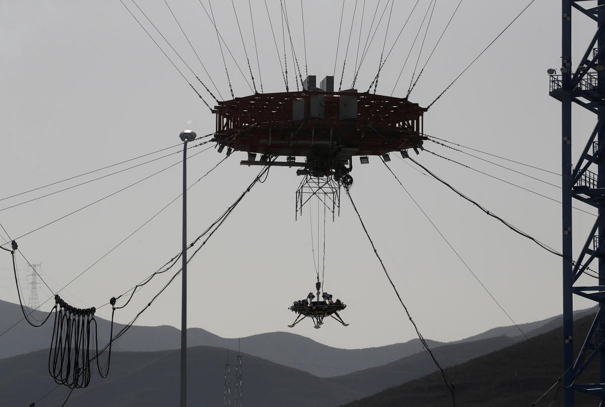 A lander for China's Mars mission is seen after a hovering-and-obstacle avoidance test at a test facility in Huailai. (Photo by REUTERS)
