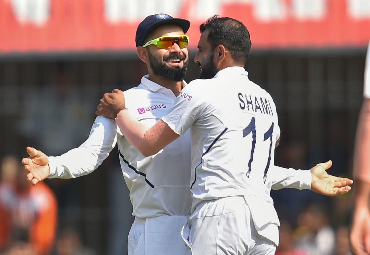 Mohammad Shami (R) celebrates with Indian captain Virat Kohli after dismissing Bangladesh batsman Mohammad Mithun. (PTI Photo)