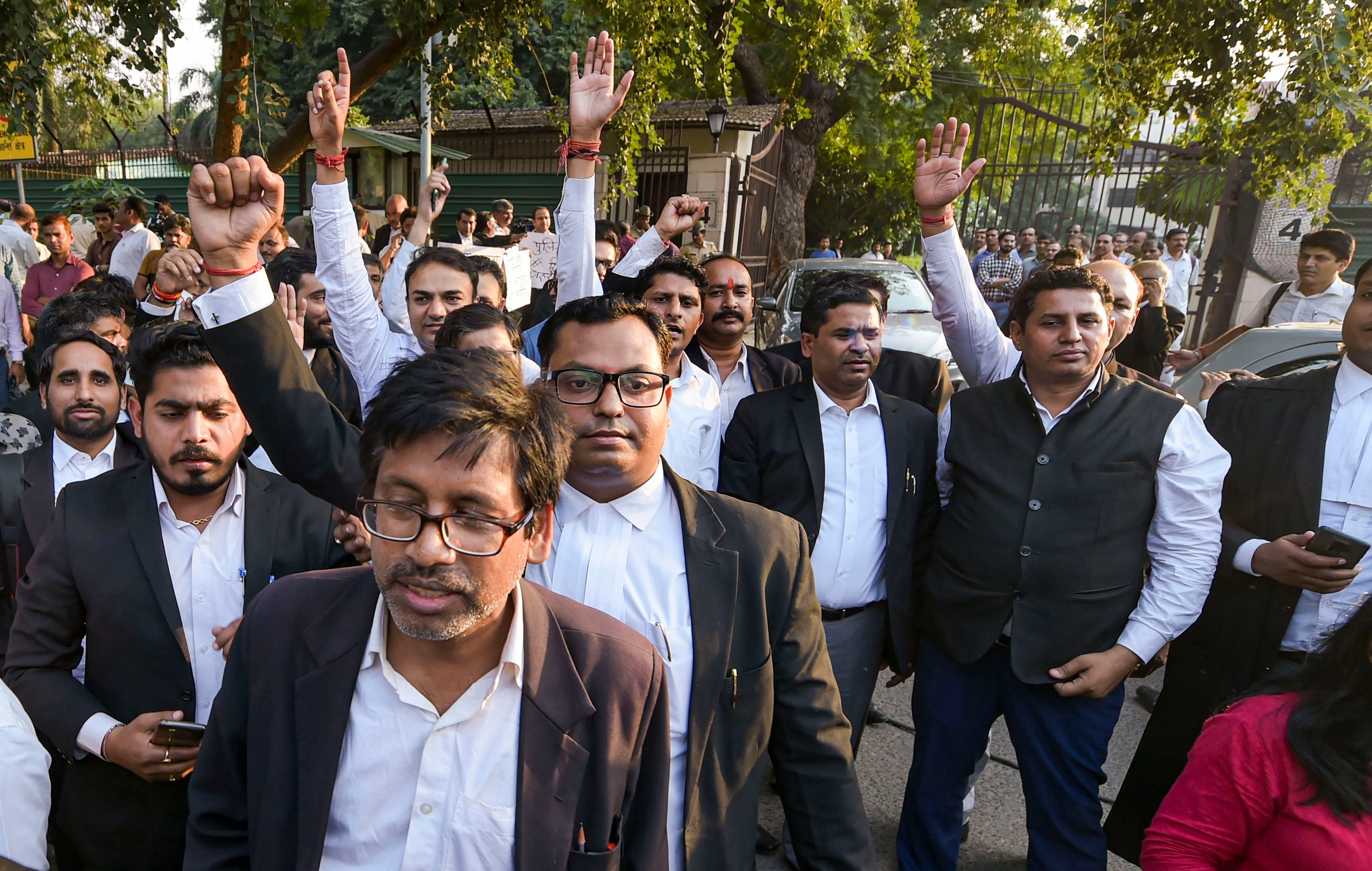 Advocates raise slogans during their protest against the police outside the Delhi High Court in New Delhi. (PTI Photo)
