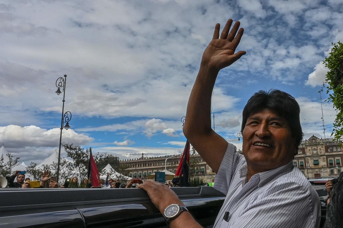Bolivian ex-President Evo Morales waves as he leaves the Historic City Hall where he was honored as Distinguished Guest by Mexico City's Mayor Claudia Sheinbaum. (Photo by AFP)