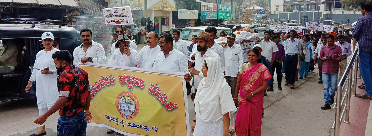 Members of Madikeri Rakshana Vedike carry out a protest rally on Friday, urging the CMC to solve various problems in the city on Friday.