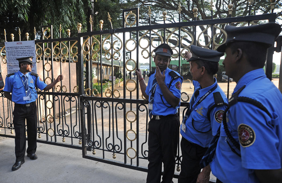 Security personnel stand guard at Bangalore Turf Club on Friday after punters went on a rampage. DH Photo/Pushkar V