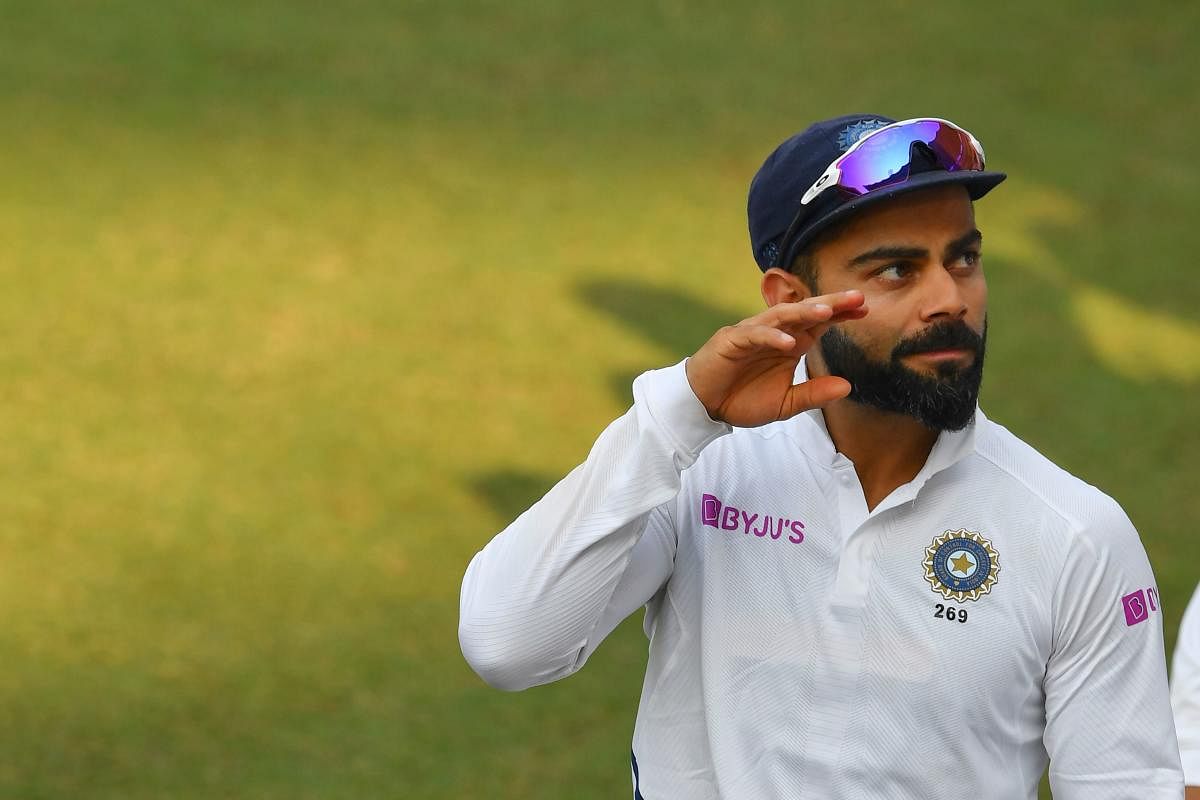 Indian cricket captain Virat Kohli waves to fans during the first Test cricket match of a two-match series between India and Bangladesh at Holkar Cricket Stadium in Indore on November 16, 2019. (AFP)