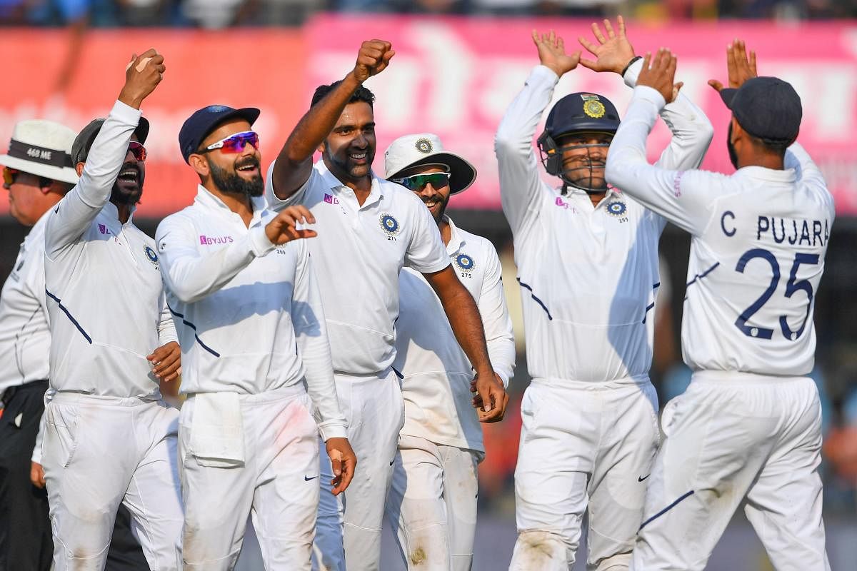 Indian cricketers celebrate the dismissal of Bangladesh's Mushfiqur Rahim during the first Test cricket match of a two-match series between India and Bangladesh at Holkar Cricket Stadium in Indore on November 16, 2019. (AFP)