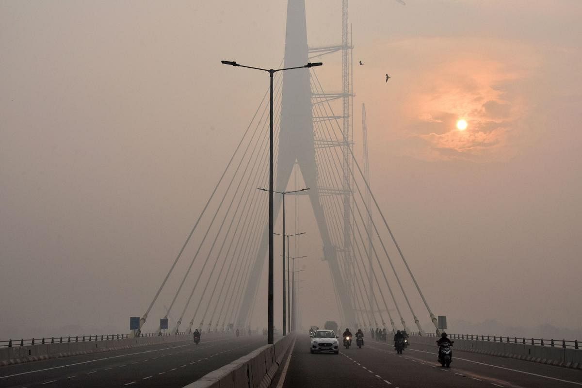 The sun is vaguely seen behind the Signature Bridge amid heavy smog, in New Delhi, Friday, Nov. 15, 2019.. (PTI Photo)