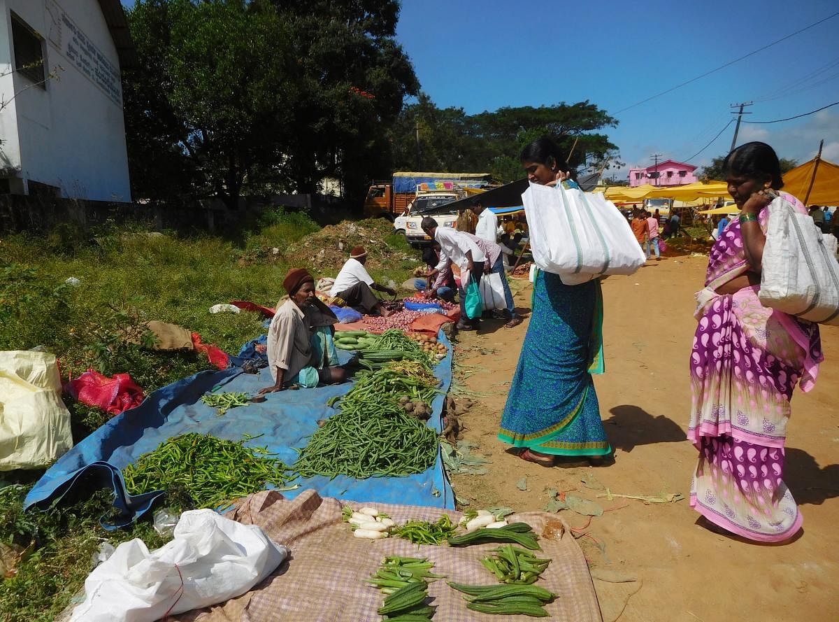Vendors sell produce in the open at the shandy in Mudigere.