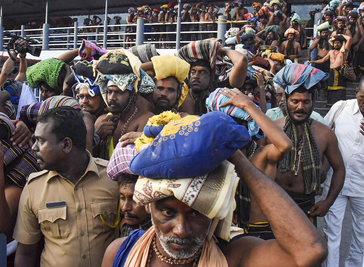 Devotees arrive at the Lord Ayyappa temple (PTI Photo)