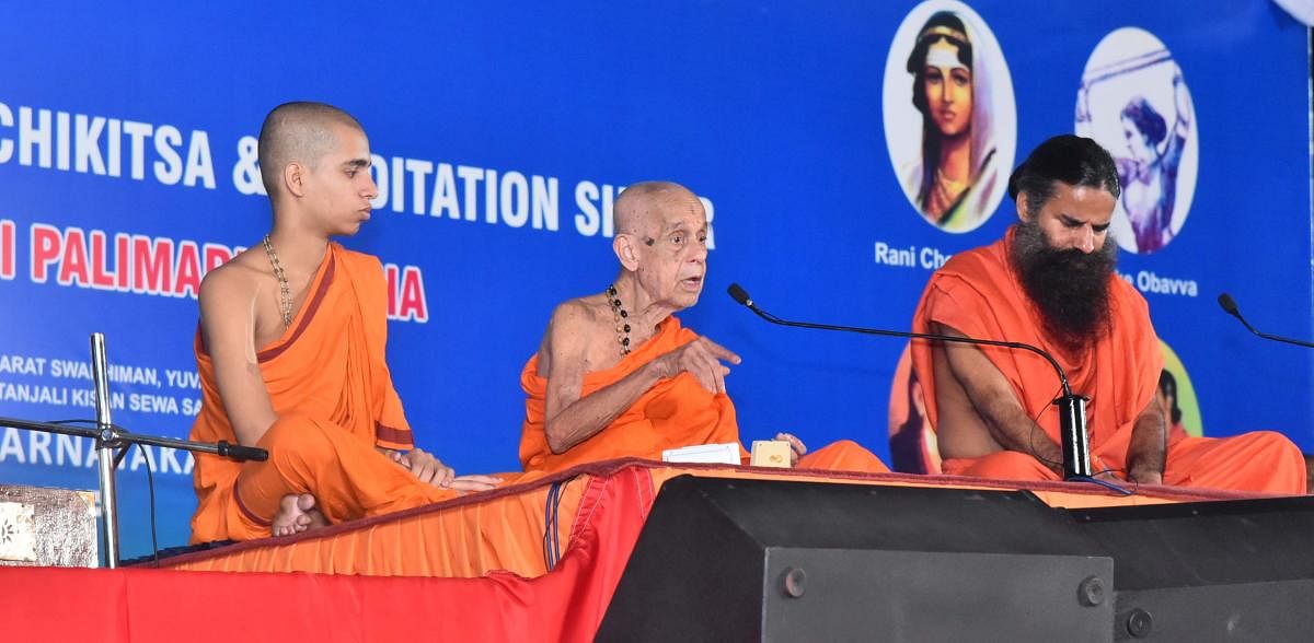 Pejawar Mutt pontiff Vishwesha Theertha Swami speaks at the Yoga camp held at parking area of Sri Krishna Mutt in Udupi on Sunday.