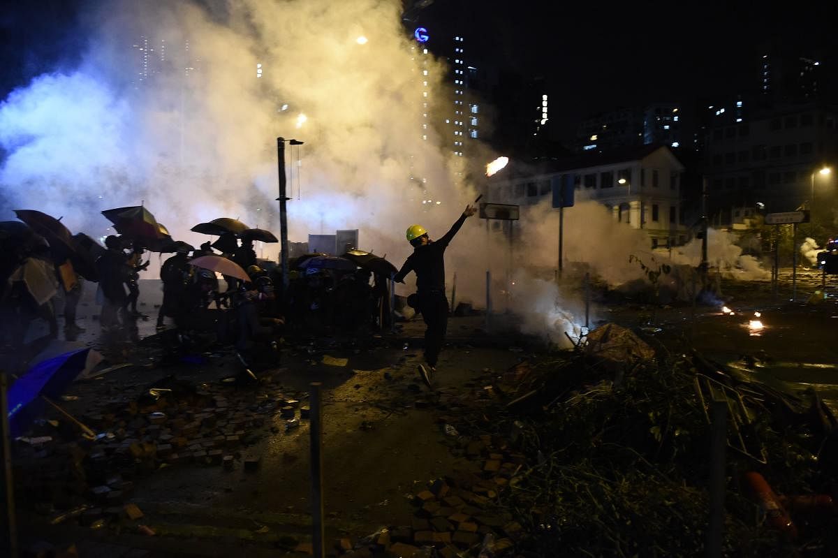 A protestor throws a petrol bomb during clashes with police outside the Polytechnic University of Hong Kong in Hung Hom district of Hong Kong. AFP