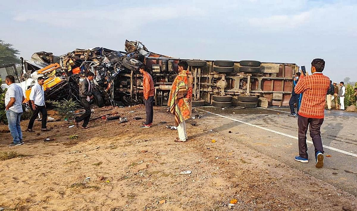 Mangled remains of a vehicle after a road accident at NH-11, in Bikaner. (PTI Photo)