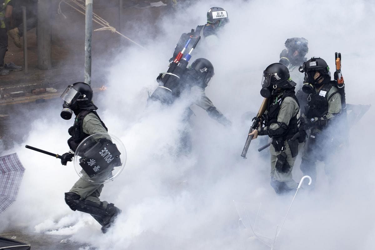 Police in riot gear move through a cloud of smoke at the Hong Kong Polytechnic University in Hong Kong. (AP/PTI Photo)