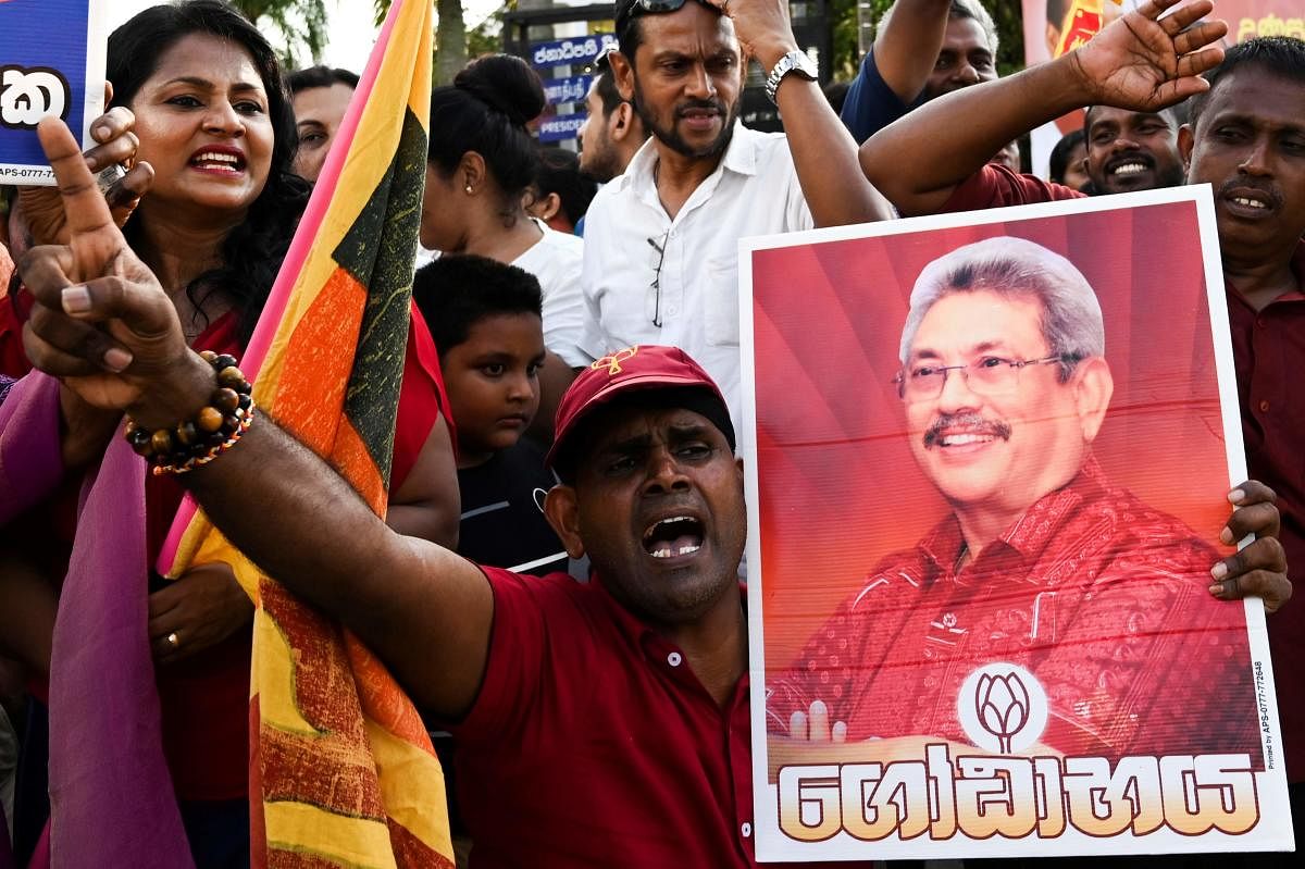 Supporters of Sri Lanka's President-elect Gotabaya Rajapaksa shout slogans as he leaves the election commission office in Colombo on November 17, 2019. AFP