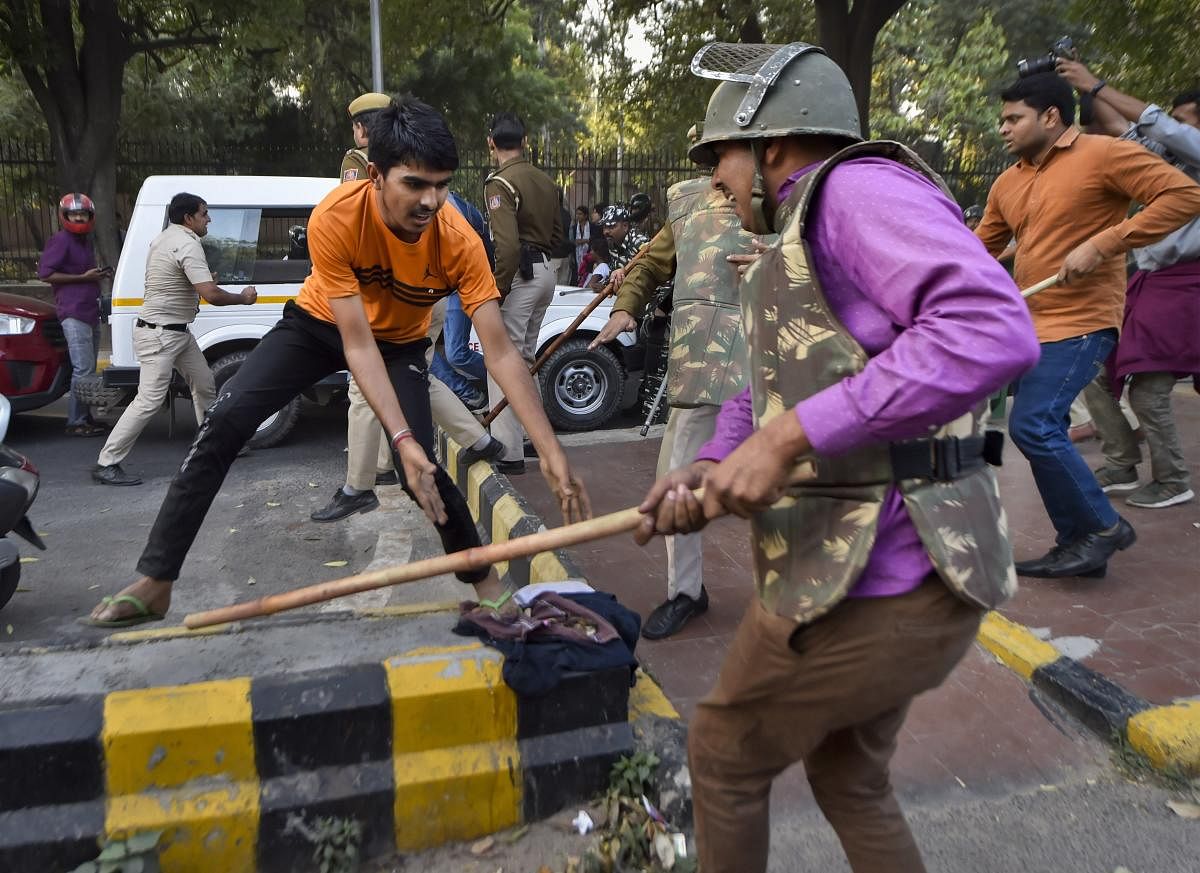 Jawaharlal Nehru University students are baton-charged by police during a protest march towards Parliament, on the first day of the Winter Session, demanding a total rollback of the hostel fee hike. (PTI Photo)