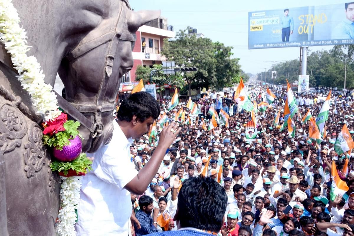 Congress candidate Lakhan Jarkiholi waves at his supporters while on his way to file nomination papers at Gokak in Belagavi district on Monday. DH photo