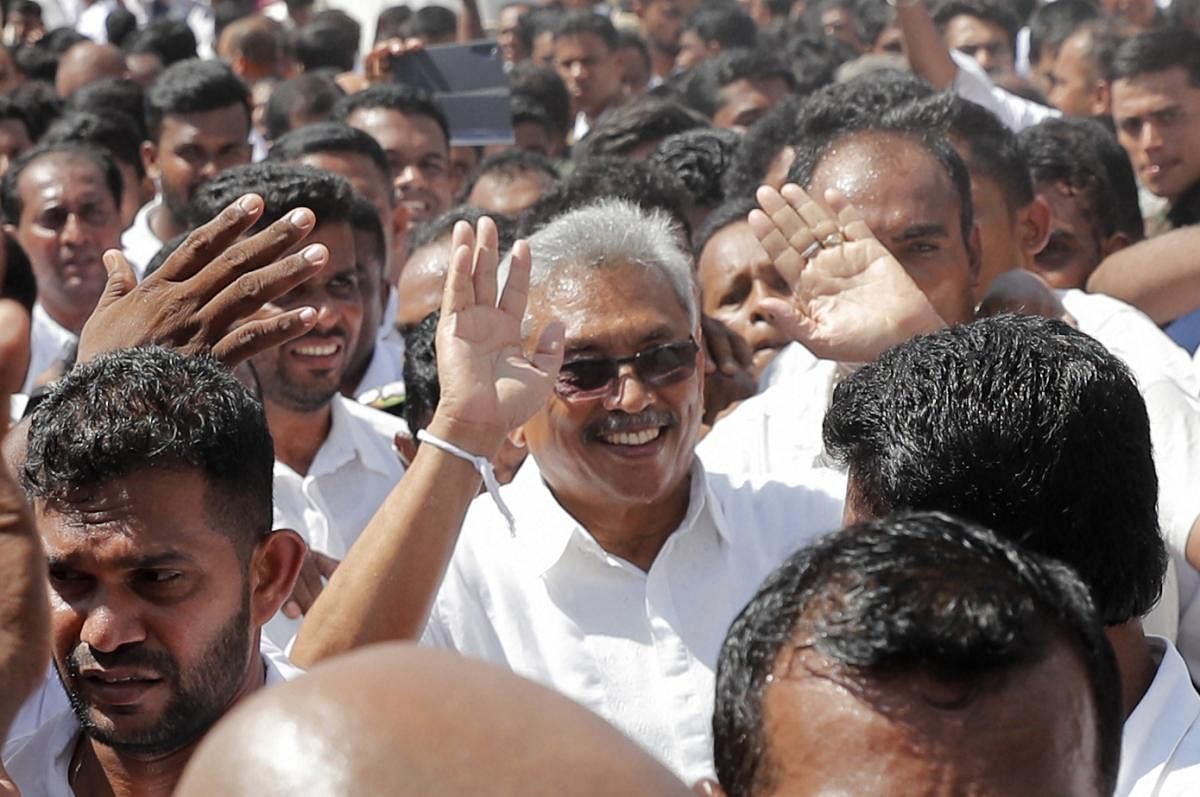 Sri Lanka's newly elected president Gotabaya Rajapaksa greets people as he leaves after taking the oath of office during the swearing in ceremony held at the 140 B.C Ruwanweli Seya Buddhist temple in ancient kingdom of Anuradhapura in northcentral Sri Lanka Monday, Nov. 18, 2019. (PTI Photo)