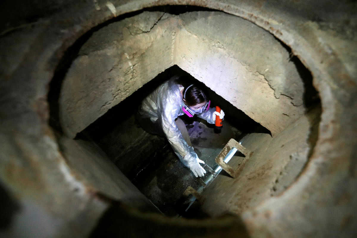 A protester tries to escape from a sewage tunnel inside the Hong Kong Polytechnic University campus during protests in Hong Kong, China, November 19, 2019. (Photo by Reuters)