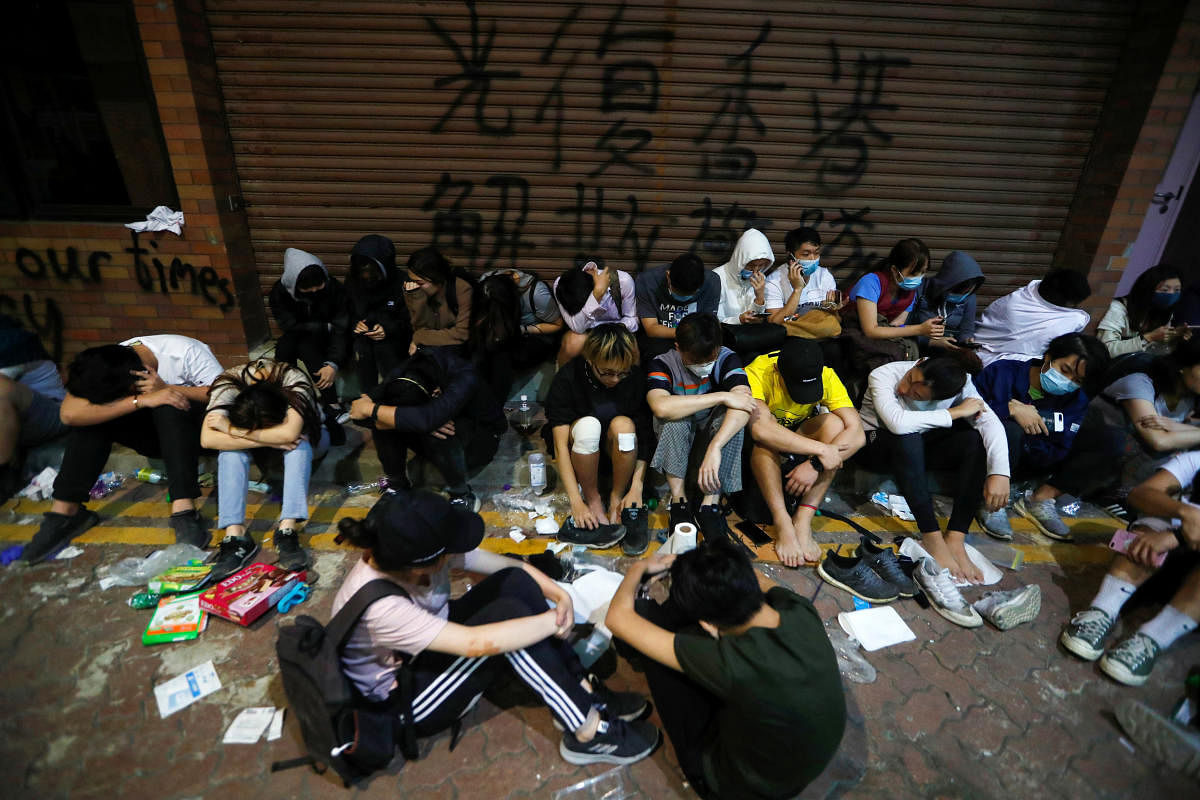 Protesters wait to receive medical attention at the Hong Kong Polytechnic University campus during protests in Hong Kong, China, November 19, 2019. (Photo by Reuters)