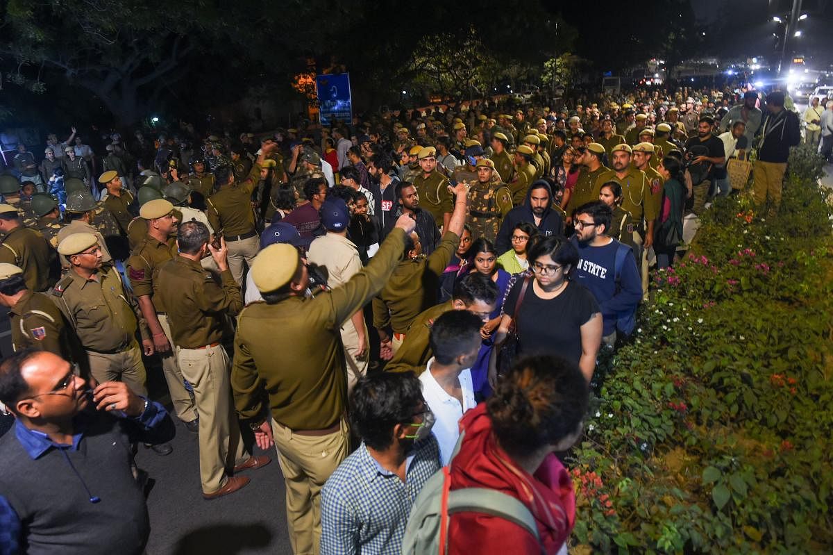 Jawaharlal Nehru University students block a road as they protest demanding a total roll back of the hostel fee hike, in New Delhi. (PTI file photo)