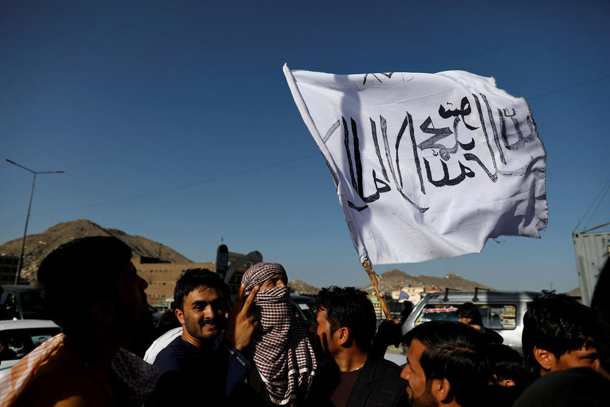  A member of the Taliban holds a flag in Kabul, Afghanistan June 16, 2018. The writing on the flag reads: 'There is no god but Allah, Muhammad is the messenger of Allah'. REUTERS/File Photo