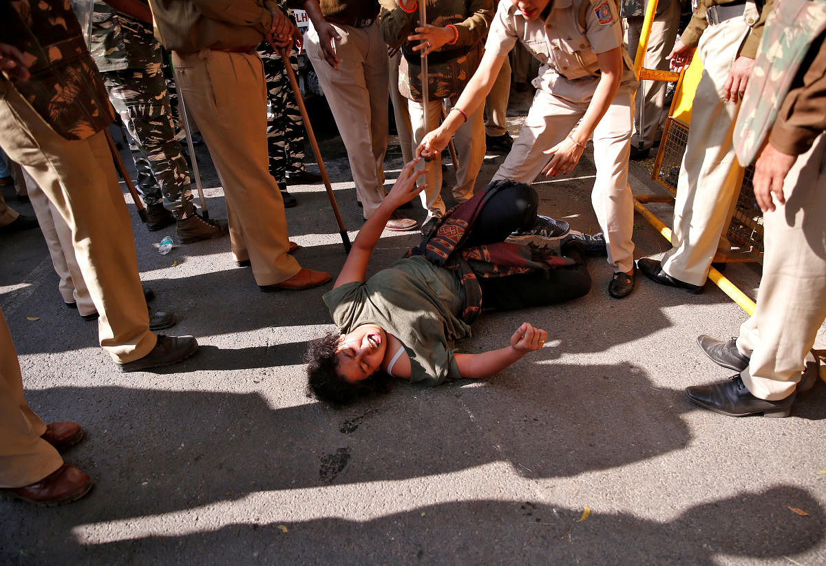 A student of Jawaharlal Nehru University (JNU) reacts as police try to detain her during a protest against a proposed fee hike, in New Delhi, India. (PTI Photo)