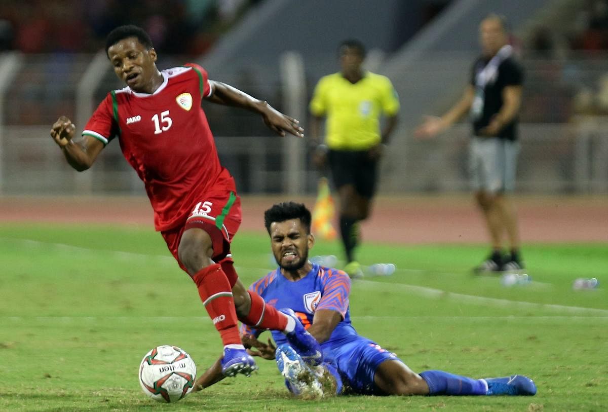 Oman's al-Mandhar al-Alwi (L) fights for the ball with India's Branon Fernandes during the FIFA World Cup 2022 and the 2023 AFC Asian Cup qualifying football match between Oman and India at the Sultan Qaboos Sports Complex. AFP