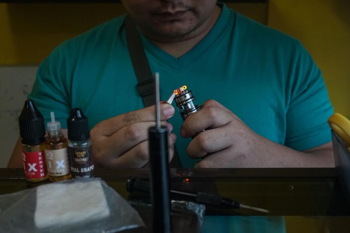 A customer prepares to smoke at a vape store in Manila. Just hours after Philippine President Rodrigo Duterte announced he would ban e-cigarette use, police were ordered on Nov. 20 to begin arresting people caught vaping in public and to confiscate the devices. Credit: Photo by Dante Diosina Jr/AFP