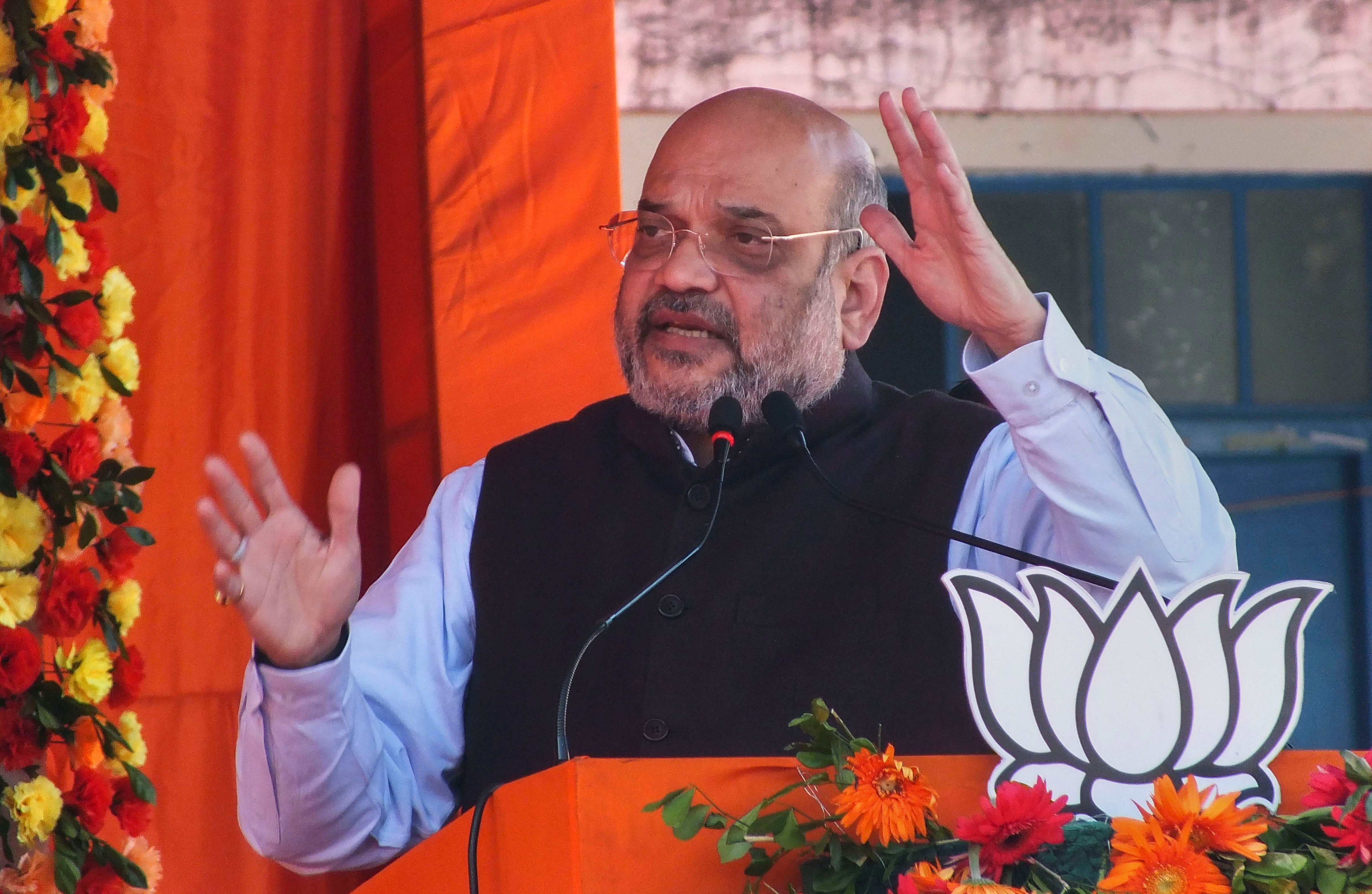 Union Home Minister and senior BJP leader Amit Shah addresses an election campaign rally ahead of the Assembly polls, at Manika in Latehar district of Jharkhand. (PTI Photo)