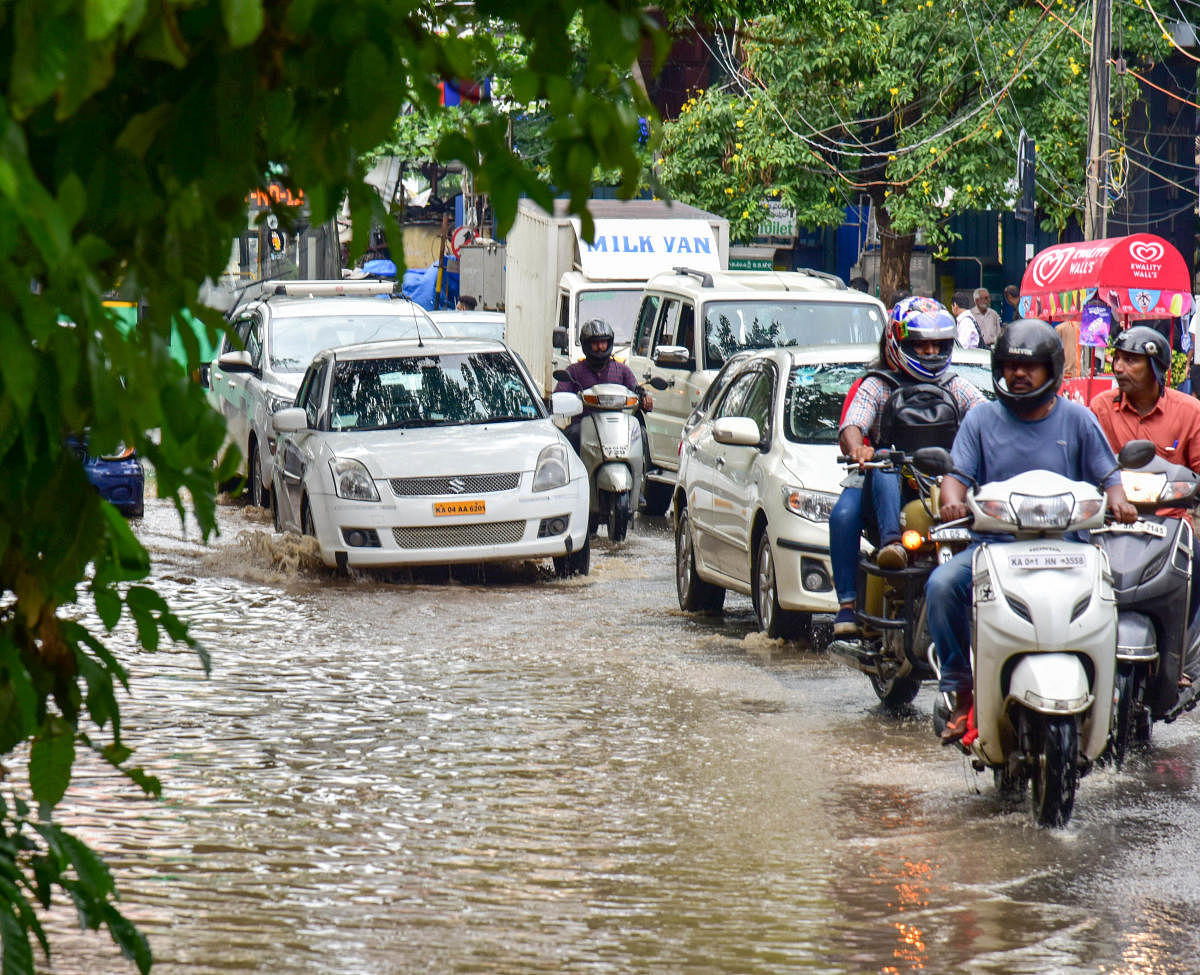 Sudden Rains lashed in the city and brought down the temperatures down drastically, Motor Vehicles struggling at Brigade road, in Bengaluru on Wednesday. Photo/ B H Shivakumar