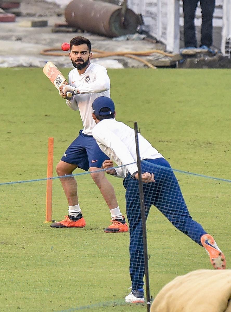 Virat Kohli gives catches during a training session ahead of first pink ball Day-Night cricket Test match between India and Bangladesh in Kolkata. PTI
