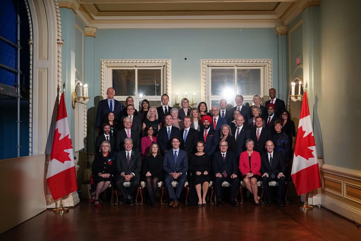 Canadian Prime Minister Justin Trudeau poses with his new cabinet following a swearing-in ceremony at Rideau Hall. (Photo by AFP)