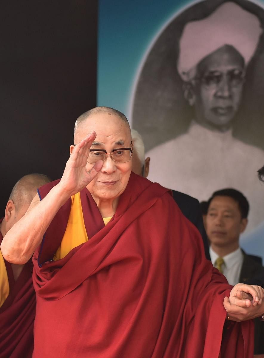 Tibetan spiritual leader the Dalai Lama waves at the gathering during the 24th S Radhakrishnan Memorial Lecture on Universal Ethics organized by the Indian Institute of Advanced Study. (PTI Photo)