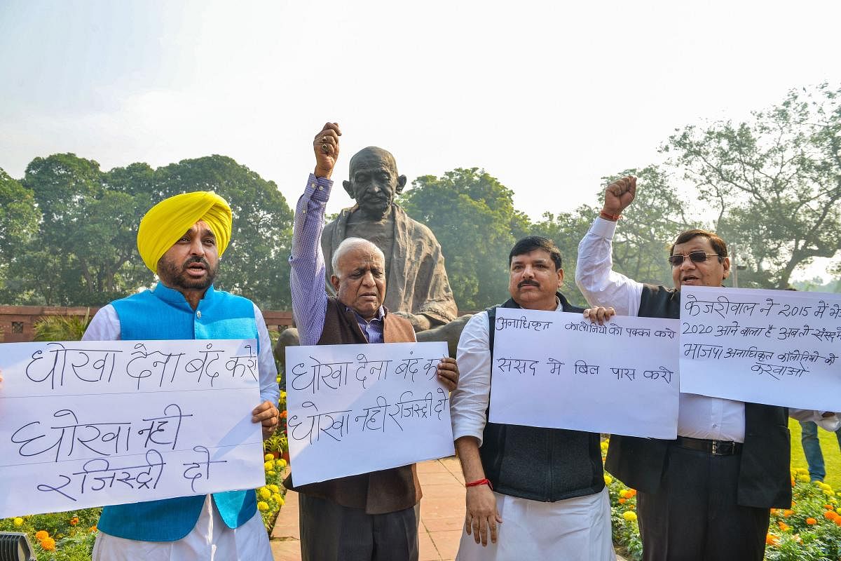  AAP MPs display placards demanding the introduction of a Bill to regularise unauthorised colonies of Delhi, during the Winter Session of Parliament (PTI photo)