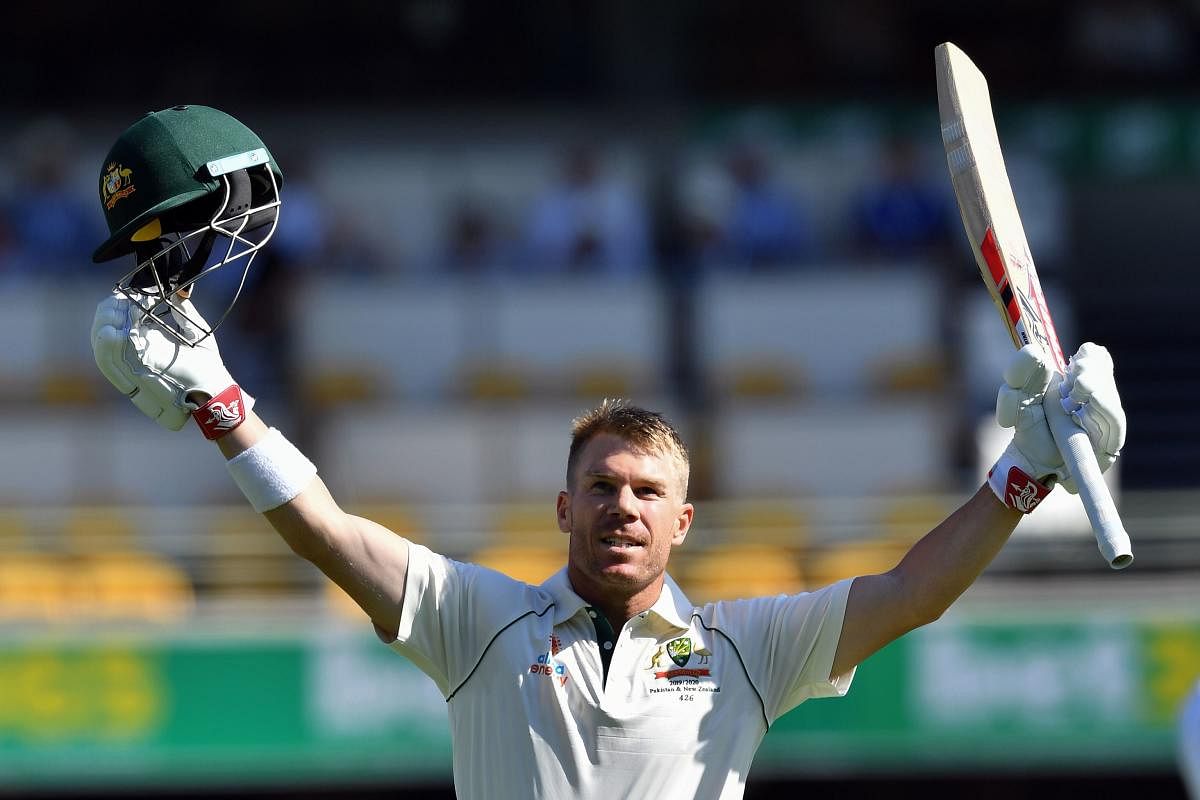 Australia's batsman David Warner celebrates reaching his century, 100 runs, on day two of the first Test cricket match between Pakistan and Australia at the Gabba in Brisbane on November 22, 2019. (Photo by Saeed KHAN / AFP)
