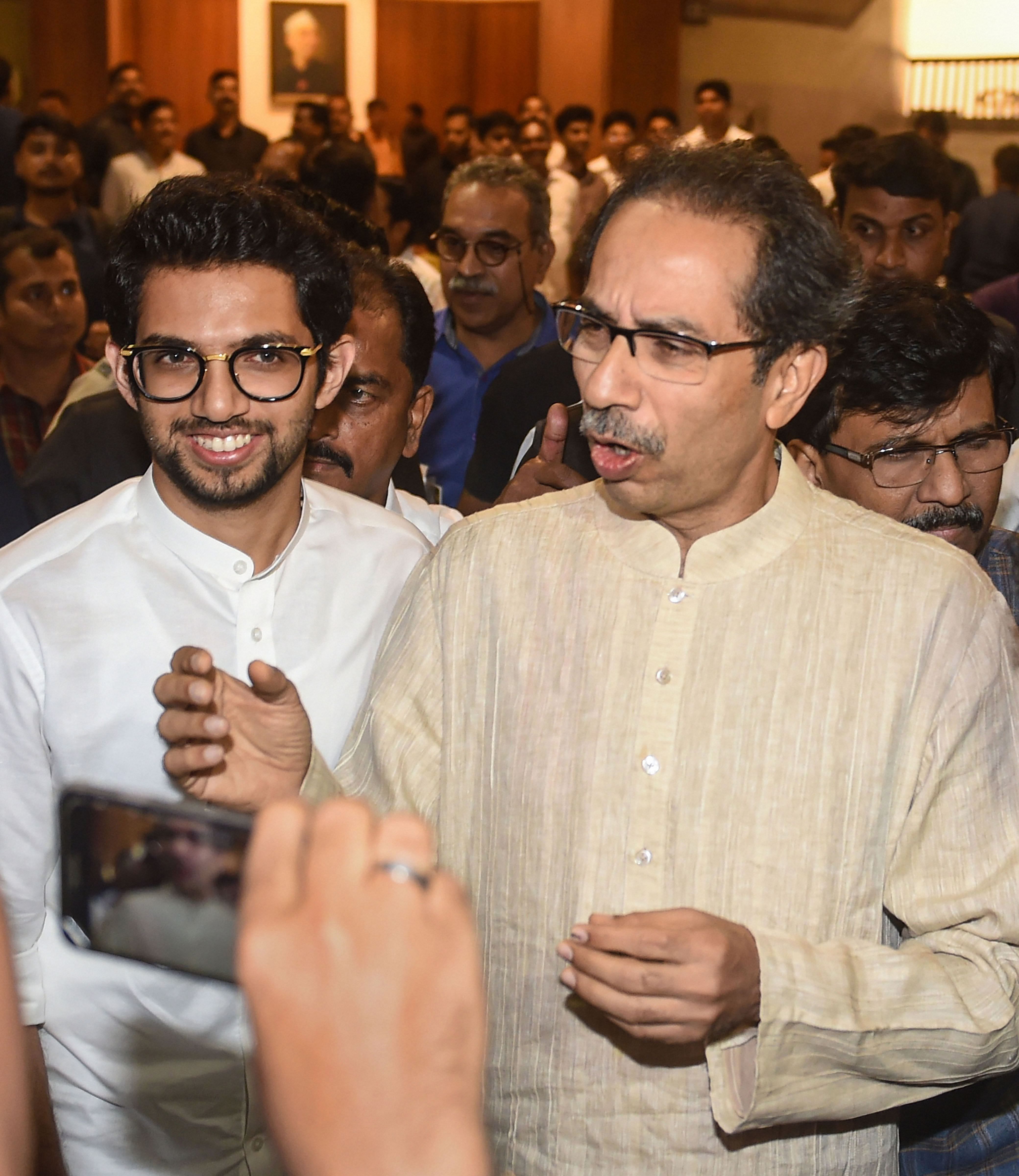 Shiv Sena chief Uddhav Thackeray and son Aaditya Thackeray leave after a meeting with Congress and NCP leaders, at Nehru Centre in Mumbai. (PTI Photo)
