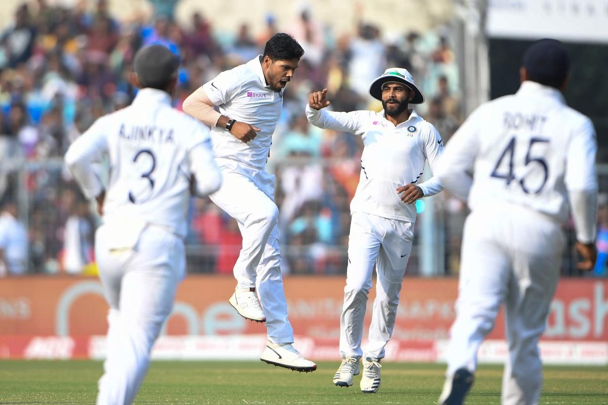 Umesh Yadav (2L) celebrates with teammates after dismissing Bangladesh's Shadman Islam (not pictured) during the first day of the second Test cricket match of a two-match series between India and Bangladesh at The Eden Gardens cricket stadium in Kolkata on November 22, 2019. (AFP)