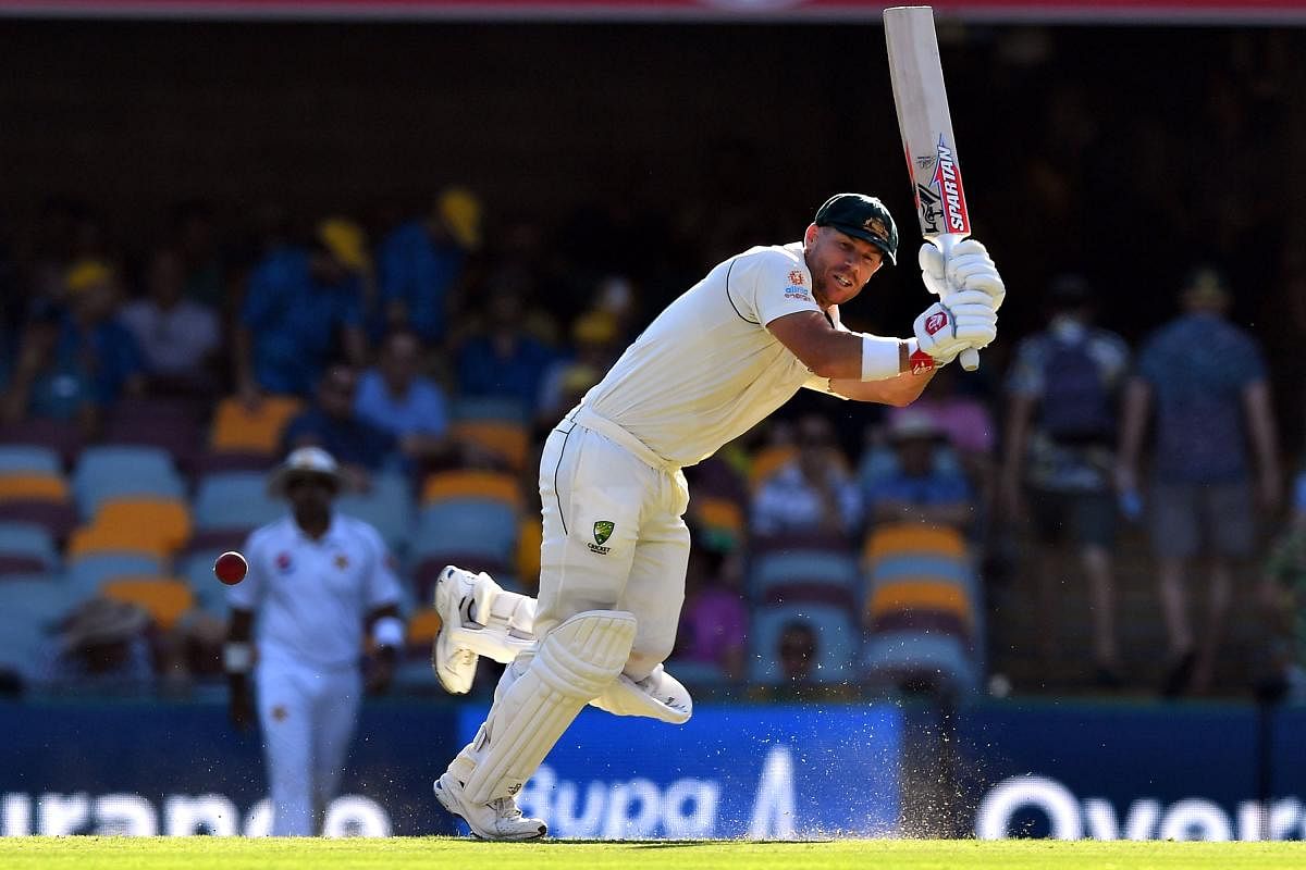 Australia's batsman David Warner plays a shot on day two of the first Test cricket match between Pakistan and Australia at the Gabba in Brisbane on November 22, 2019. (Photo by Saeed KHAN / AFP)